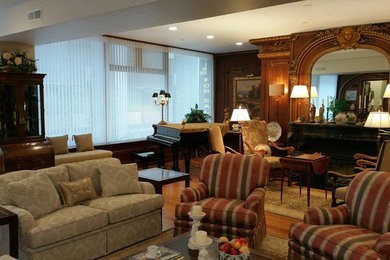 Living room - medium tone wood floor living room idea in Boston with white walls