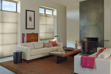 Inspiration for a mid-sized contemporary formal and enclosed medium tone wood floor and brown floor living room remodel in Phoenix with white walls, a standard fireplace, a concrete fireplace and no tv