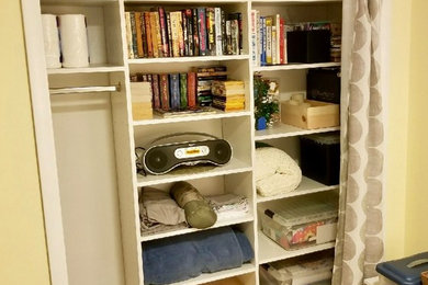 Reach-in closet - small traditional gender-neutral carpeted and beige floor reach-in closet idea in Salt Lake City with flat-panel cabinets and white cabinets