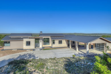 Inspiration for a mid-sized contemporary beige one-story stucco gable roof remodel in Austin