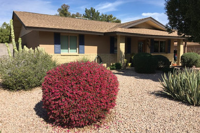 Inspiration for a mid-sized southwestern brown one-story mixed siding exterior home remodel in Phoenix with a shingle roof