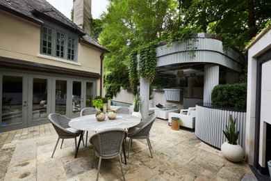Photo of a mid-sized transitional partial sun backyard stone and wood fence formal garden in Toronto with a pergola for summer.