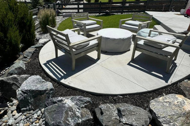 Example of a mid-sized 1960s backyard concrete patio design in Denver with a fire pit and no cover