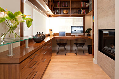 Design ideas for a modern home office in Calgary with a built-in desk.