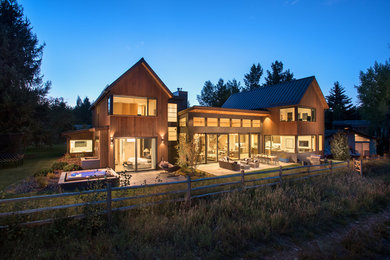 Large rustic two-story wood exterior home idea in Denver with a metal roof