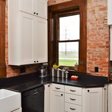 Bourbon, IN. Haas Signature Collection. Farmhouse Kitchen with Exposed Brick