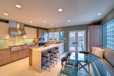 Inspiration for a large modern galley porcelain tile and beige floor eat-in kitchen remodel in Other with flat-panel cabinets, medium tone wood cabinets, quartz countertops and stainless steel appliances