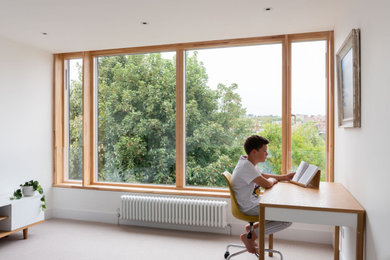 This is an example of a medium sized modern mezzanine bedroom in London.