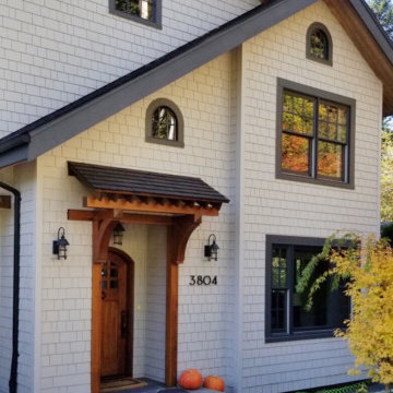 Exterior makeover with stained cedar shake siding and wood accents