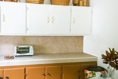 Small island style l-shaped cement tile floor and brown floor enclosed kitchen photo in Other with brown cabinets, tile countertops, beige backsplash, ceramic backsplash and no island