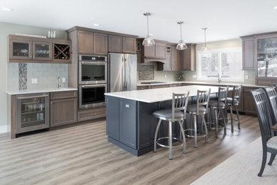 Large elegant kitchen photo in Grand Rapids with shaker cabinets and an island