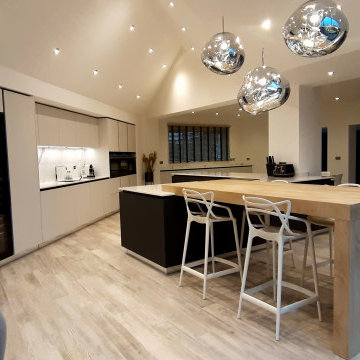 Contemporary open plan kitchen extension with a high vaulted ceiling