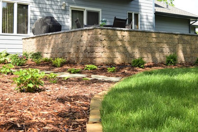 Design ideas for a traditional backyard retaining wall landscape in Minneapolis.