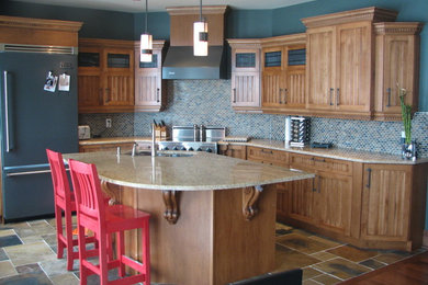Open concept kitchen - large rustic slate floor open concept kitchen idea in Ottawa with an undermount sink, shaker cabinets, medium tone wood cabinets, granite countertops, ceramic backsplash, colored appliances and an island