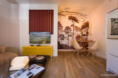 Photo of a mid-sized scandinavian open concept family room in Paris with beige walls, laminate floors, no fireplace, a wall-mounted tv, brown floor and wallpaper.