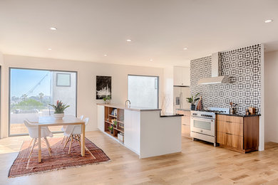 Inspiration for a contemporary light wood floor kitchen remodel in Other with dark wood cabinets, marble countertops, stainless steel appliances and an island