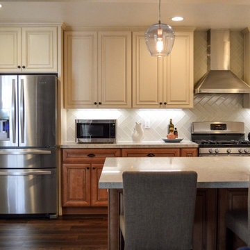 Antique white kitchen upper cabinet with cinnamon cabinets and Quartz countertop