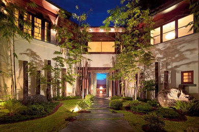 Inspiration for a huge asian slate floor entryway remodel in Miami with white walls