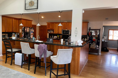 Example of a mid-sized farmhouse home design design in Denver