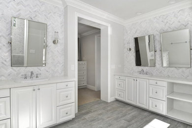 Example of a transitional gray tile and marble tile porcelain tile and gray floor bathroom design in Orange County with raised-panel cabinets
