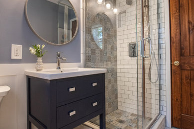 Example of a small transitional ceramic tile ceramic tile, white floor and wainscoting bathroom design in Denver with open cabinets, blue cabinets, a two-piece toilet, blue walls, an integrated sink, white countertops and a freestanding vanity
