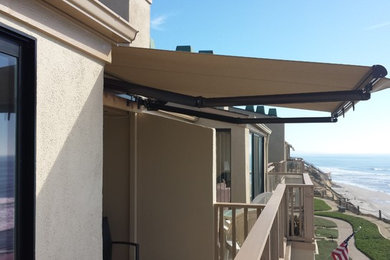Mid-sized trendy backyard deck photo in San Diego with an awning