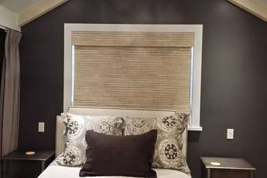 Inspiration for a mid-sized transitional medium tone wood floor and brown floor bedroom remodel in Other with gray walls and no fireplace