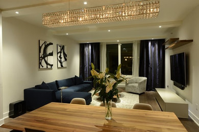Inspiration for a mid-sized contemporary open concept medium tone wood floor living room remodel in New York with white walls and a wall-mounted tv
