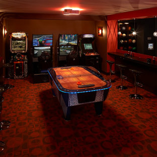 Design ideas for a large fully buried basement in Minneapolis with red walls, carpet, no fireplace and red floors.