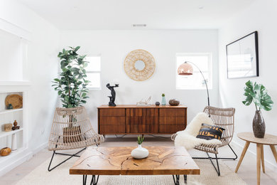 Inspiration for a contemporary living room in Los Angeles with white walls, light hardwood floors and beige floor.