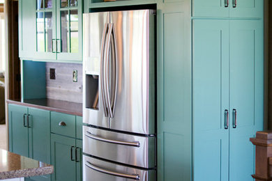 Large transitional l-shaped dark wood floor eat-in kitchen photo in Other with a farmhouse sink, flat-panel cabinets, blue cabinets, quartzite countertops, stainless steel appliances and an island