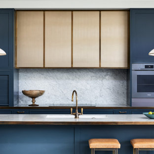 Inspiration for a mid-sized transitional galley eat-in kitchen in Other with a double-bowl sink, shaker cabinets, blue cabinets, marble benchtops, grey splashback, marble splashback, stainless steel appliances, marble floors, with island, grey floor, grey benchtop and wood.