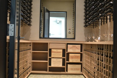 Design ideas for a large modern wine cellar in San Francisco with travertine floors and storage racks.