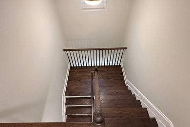 Example of a mid-sized classic wooden u-shaped mixed material railing staircase design in New York with wooden risers