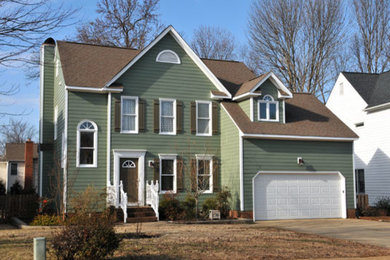 Example of a mid-sized classic green two-story wood gable roof design in Charlotte