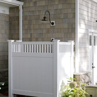 Photo of an expansive traditional patio in Other with an outdoor shower and stamped concrete.