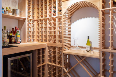Example of a small classic brown floor wine cellar design in New York with storage racks