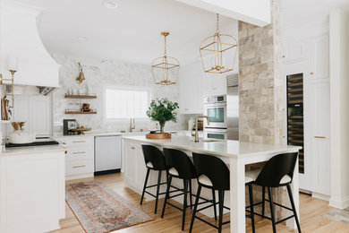 Example of a large classic u-shaped medium tone wood floor eat-in kitchen design in Other with an undermount sink, beaded inset cabinets, white cabinets, quartz countertops, white backsplash, porcelain backsplash, stainless steel appliances, an island and white countertops