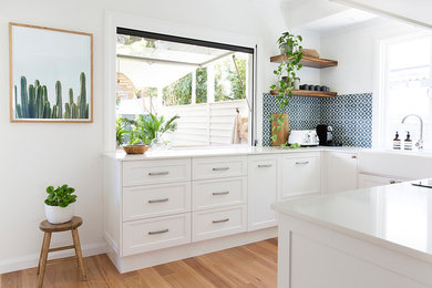 This is an example of a beach style kitchen in Brisbane.