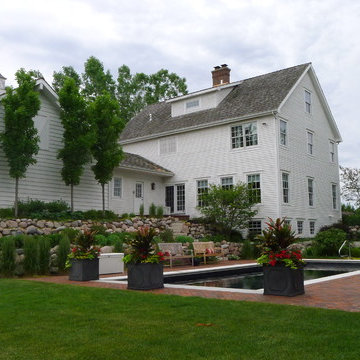 Dark bottom pool with boulder retaining wall