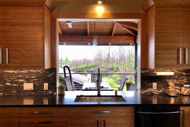 Example of a trendy slate floor and black floor open concept kitchen design in Hawaii with an undermount sink, flat-panel cabinets, light wood cabinets, granite countertops, multicolored backsplash, granite backsplash, stainless steel appliances, an island and black countertops