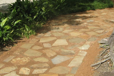 Inspiration for a mid-sized traditional full sun side yard stone garden path in New Orleans.