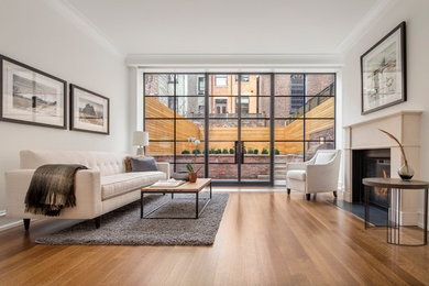 Family room - mid-sized transitional open concept dark wood floor family room idea in New York with a standard fireplace, a stone fireplace and a wall-mounted tv