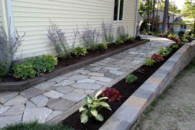 This is an example of a mid-sized traditional shade side yard stone garden path in Other.