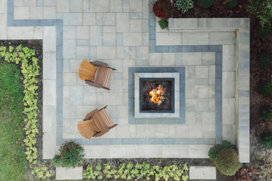Inspiration for a huge craftsman partial sun backyard brick landscaping in Detroit with a fire pit for fall.