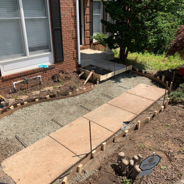 Limestone walkway with brick ascent to match house