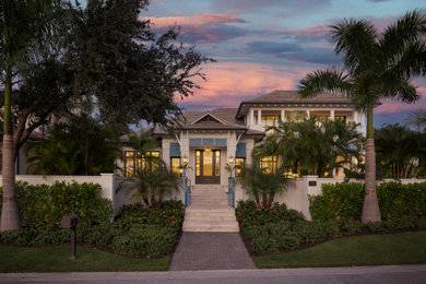 Inspiration for a large coastal two-story exterior home remodel in Tampa