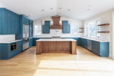 Inspiration for a large craftsman u-shaped kitchen remodel in Omaha with an undermount sink, quartz countertops and yellow backsplash