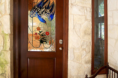 Example of a large mountain style front door design in Austin with white walls
