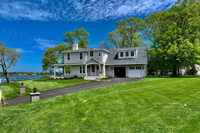 Gray two-story vinyl house exterior idea in New York with a shingle roof